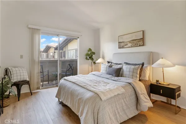 a bedroom with a bed and wooden floor