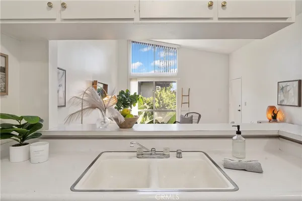 a bathroom with a sink a vanity and a window