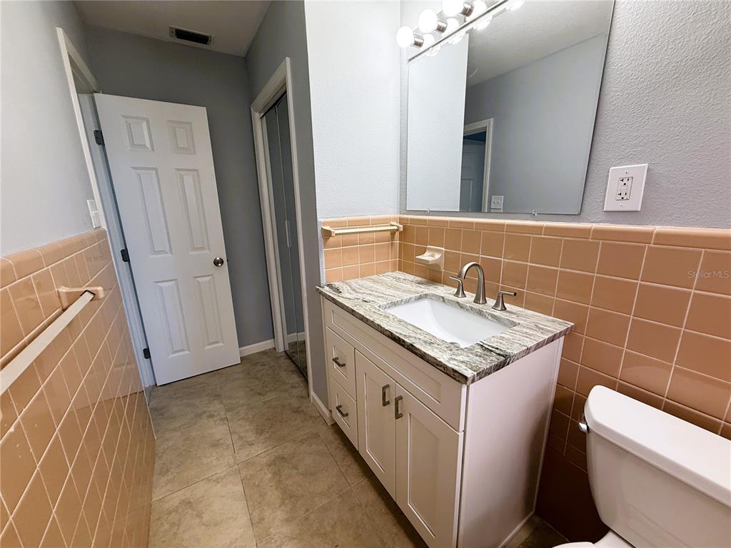 500 140th Avenue East Madeira Beach, FL 33708 - Photo 15 of 30 a bathroom with a granite countertop sink and a mirror