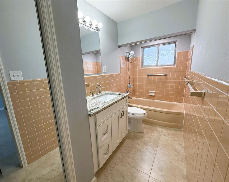500 140th Avenue East Madeira Beach, FL 33708 - Photo 16 of 30 a bathroom with a granite countertop sink toilet and shower