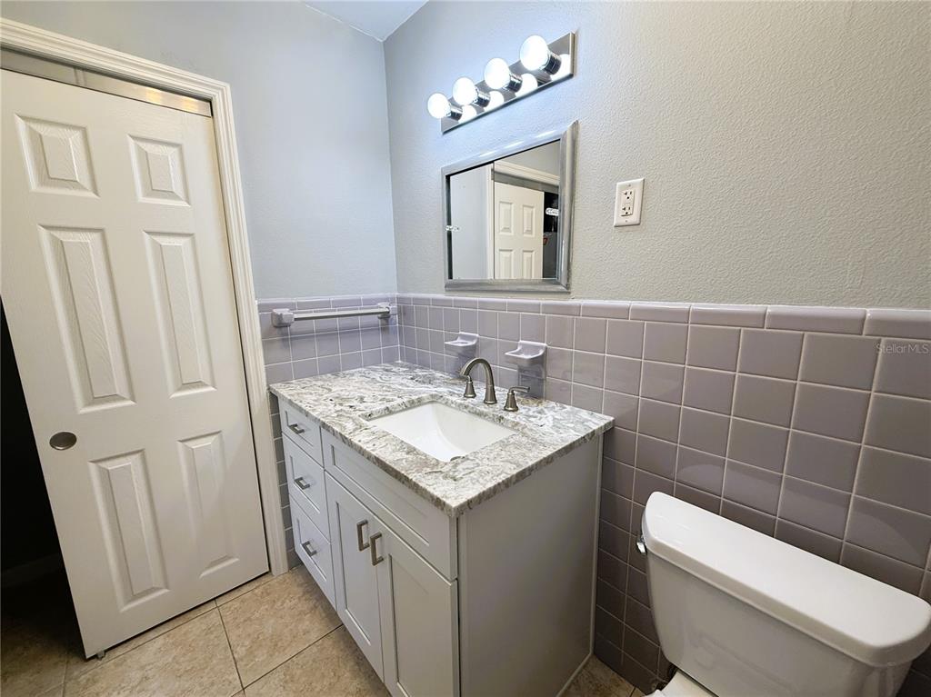 500 140th Avenue East Madeira Beach, FL 33708 - Photo 6 of 30 a bathroom with a toilet a sink a mirror and a shower