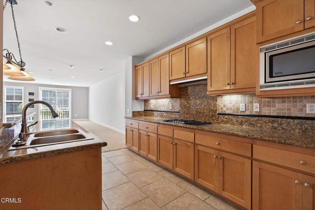 1423 Windshore Way Oxnard, CA 93035 - Photo 20 of 77 a kitchen with stainless steel appliances granite countertop a sink stove and cabinets
