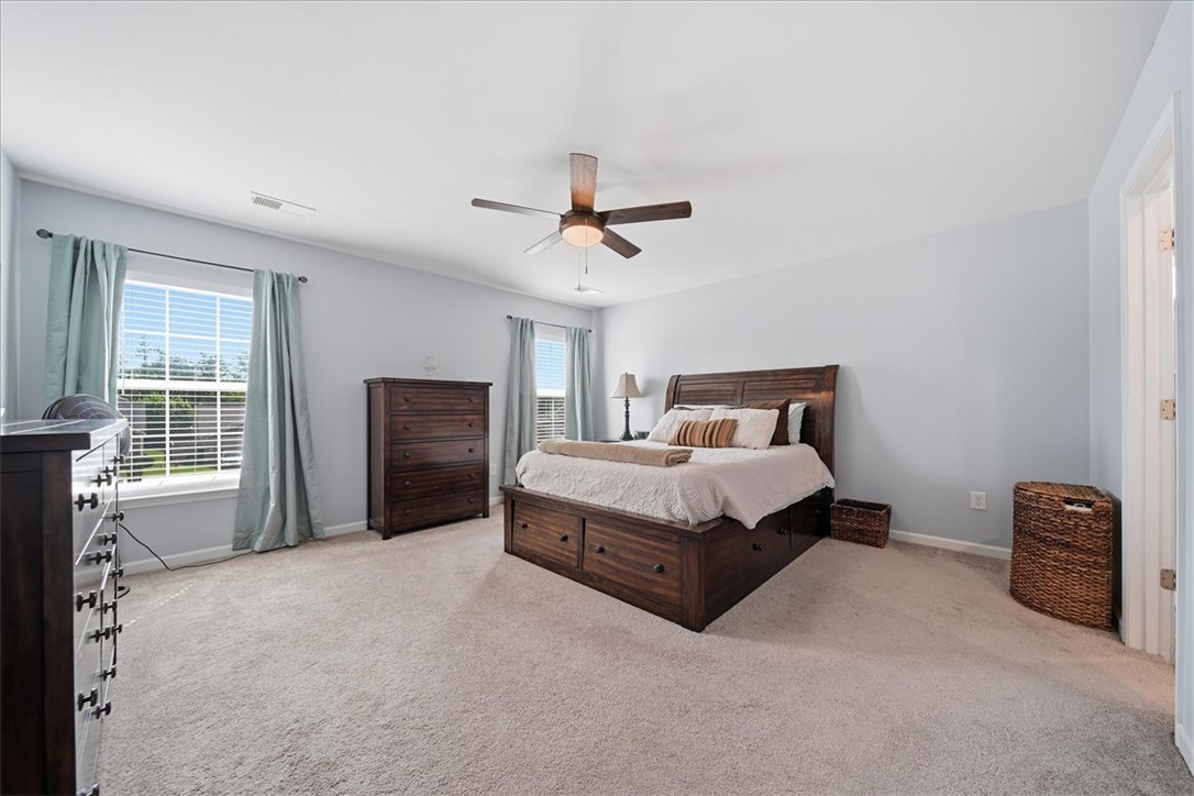 208 Grassy Creek Way Pendleton, SC 29670 - Photo 26 of 43 A tranquil primary bedroom with a vaulted ceiling and ample natural light from generous windows.