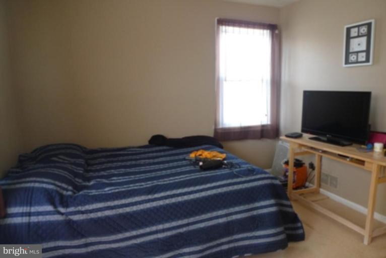 1822 Forrest Road Parkville, MD 21234 - Photo 19 of 21 a bedroom with a bed and a flat screen tv