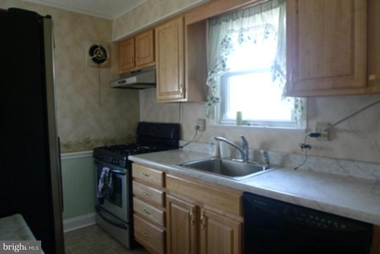 1822 Forrest Road Parkville, MD 21234 - Photo 3 of 21 a kitchen with a sink cabinets and window