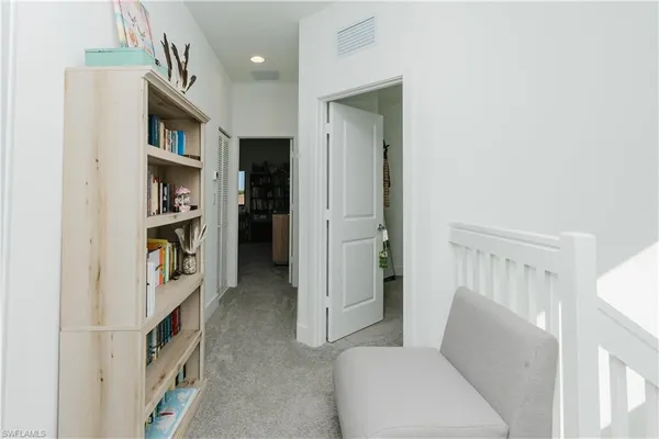 a living room with furniture and a walk in closet