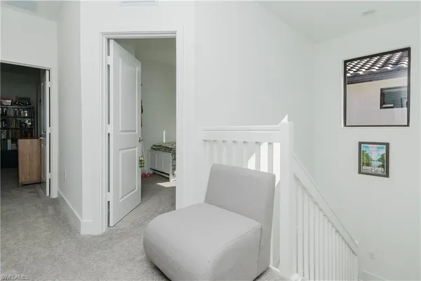 a bathroom with a toilet and a hallway