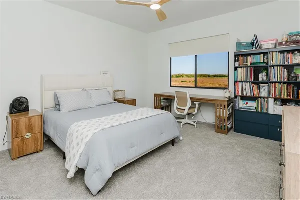 a bedroom with a bed furniture and a book shelf