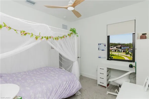a bedroom with a bed and a table