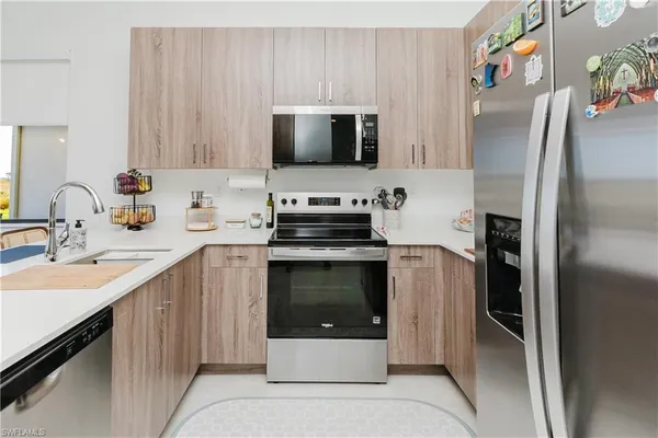 a kitchen with a sink stove and refrigerator