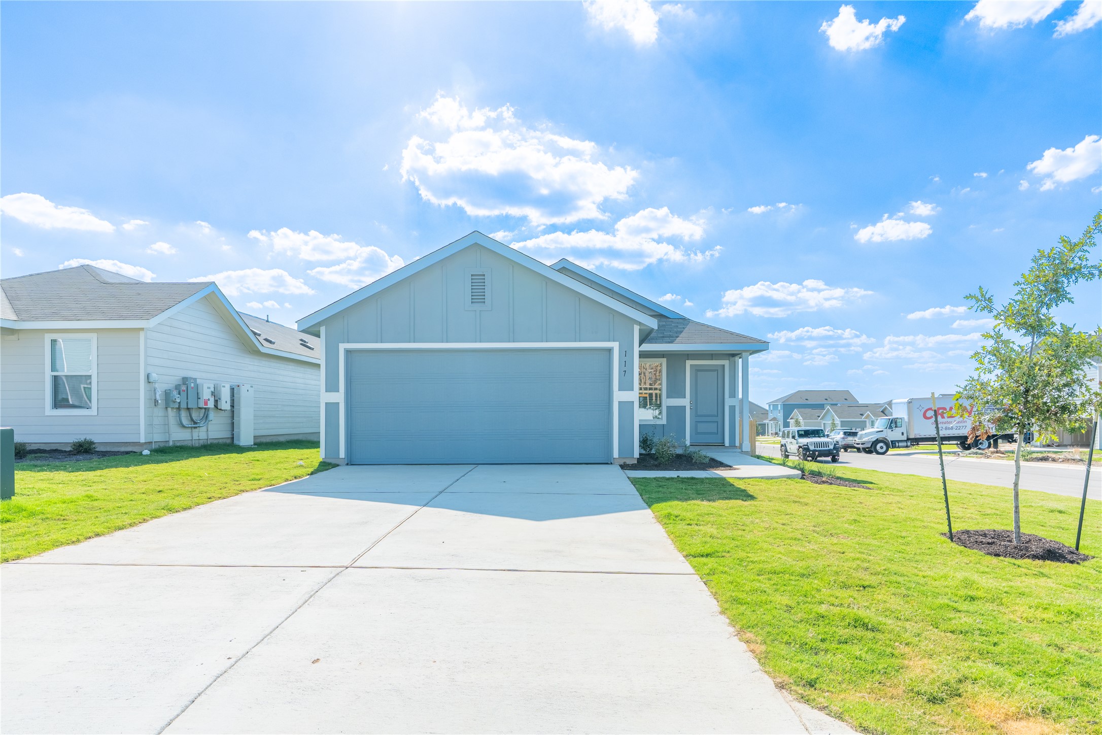 117 Dark Victory Road Jarrell, TX 76537 - Photo 1 of 24 Ranch-style home featuring board and batten siding, a front lawn, concrete driveway, and an attached garage