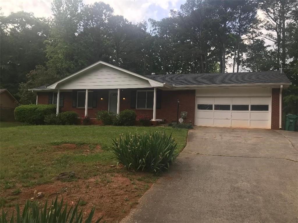 4450 Huntsman Bend Decatur, GA 30034 - Photo 1 of 1 a front view of a house with a garden and trees