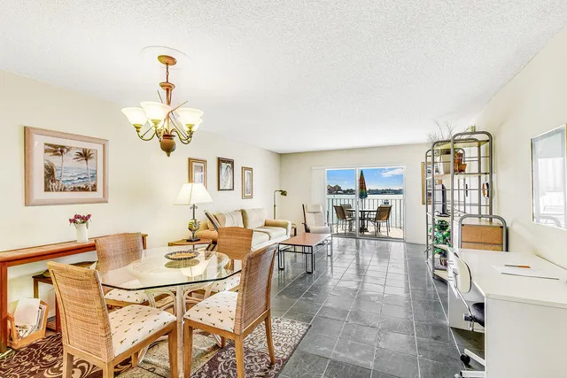 a living room with furniture a rug and a window