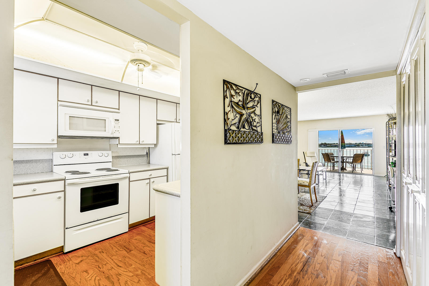 1025 Sugar Sands Boulevard, Unit 360 Singer Island, FL 33404 - Photo 18 of 25 a kitchen with stainless steel appliances a stove a refrigerator and cabinets