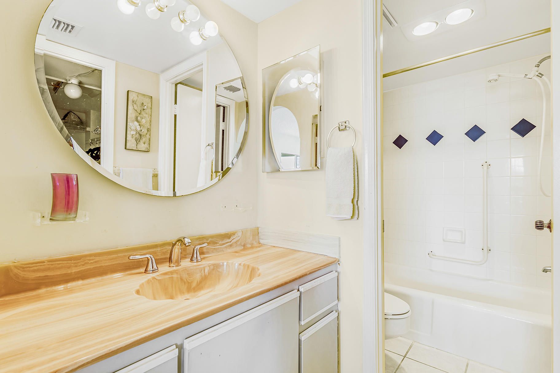 1025 Sugar Sands Boulevard, Unit 360 Singer Island, FL 33404 - Photo 23 of 25 a bathroom with a granite countertop shower sink and mirror