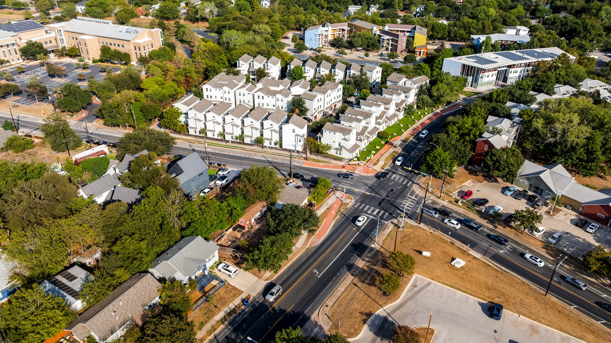 2900 Webberville Road Austin, TX 78702 - Photo 12 of 22 An aerial perspective captures the vibrant neighborhood layout with modern multi-family residences and tree-lined streets.