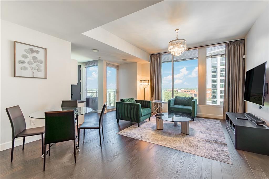1820 Peachtree Road Northwest, Unit 1111 Atlanta, GA 30309 - Photo 11 of 41 a living room with furniture flat screen tv and wooden floor