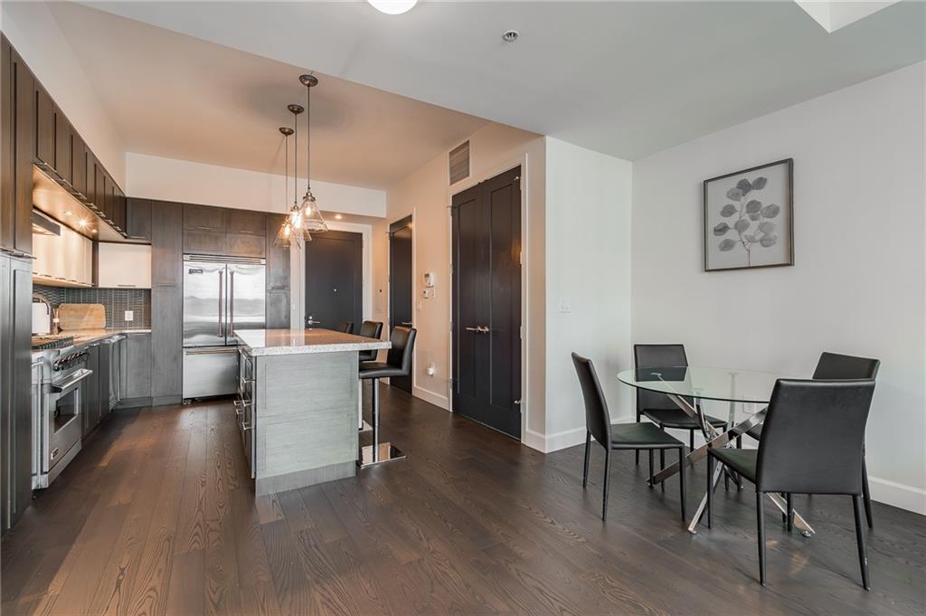 1820 Peachtree Road Northwest, Unit 1111 Atlanta, GA 30309 - Photo 12 of 41 a view of a dining room with furniture and wooden floor