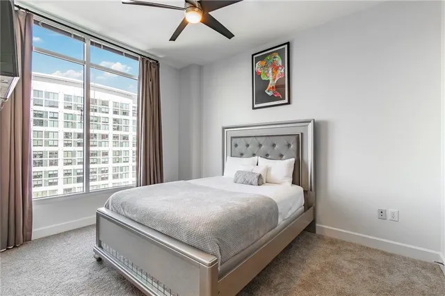 a bedroom with a large bed and a window