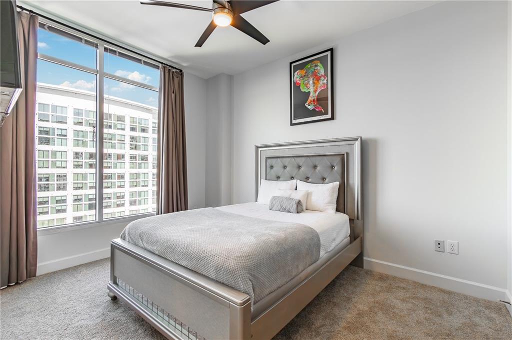 1820 Peachtree Road Northwest, Unit 1111 Atlanta, GA 30309 - Photo 14 of 41 a bedroom with a large bed and a window