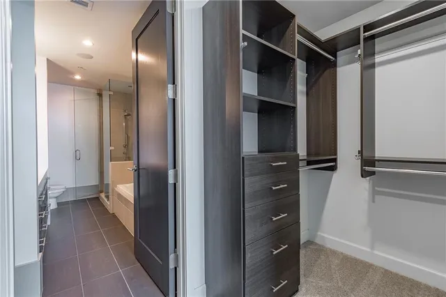 a view of a hallway with closet and wooden floor