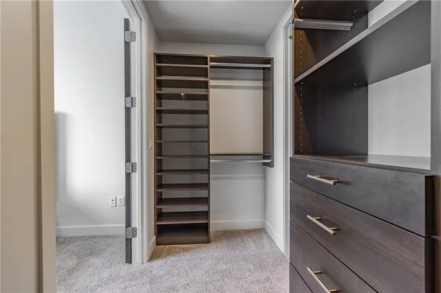 a view of walk in closet with empty racks