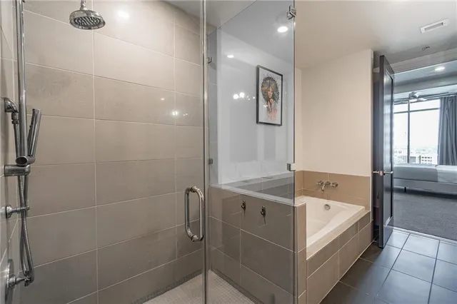 a bathroom with a tub and shower