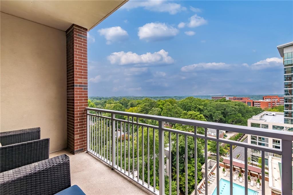 1820 Peachtree Road Northwest, Unit 1111 Atlanta, GA 30309 - Photo 22 of 41 a view of a balcony with wooden floor and fence