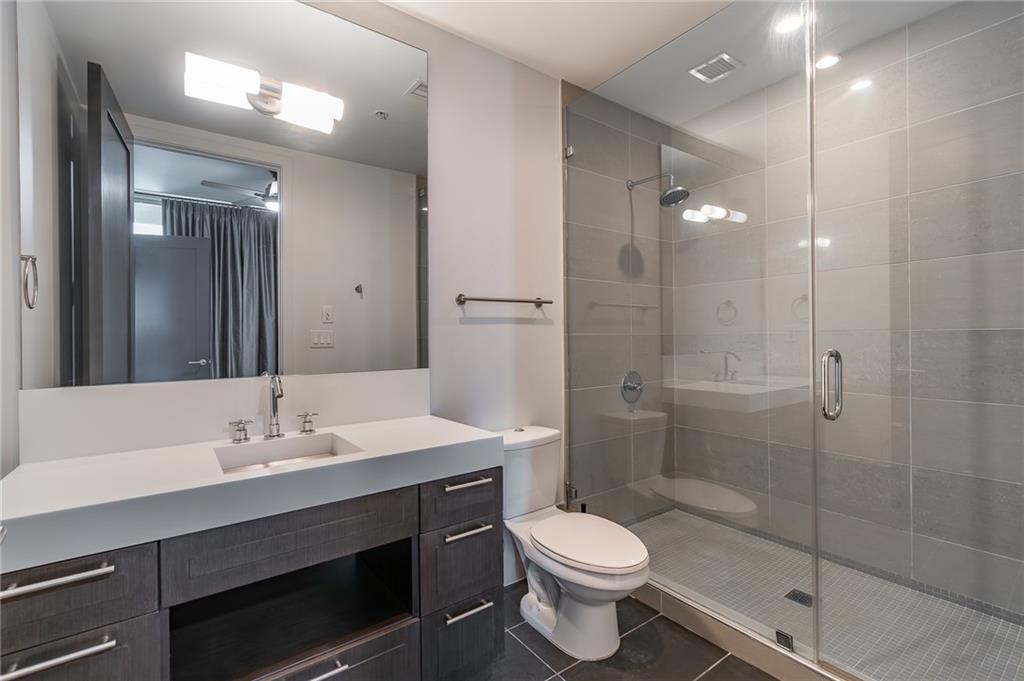 1820 Peachtree Road Northwest, Unit 1111 Atlanta, GA 30309 - Photo 26 of 41 a bathroom with a sink a toilet and shower