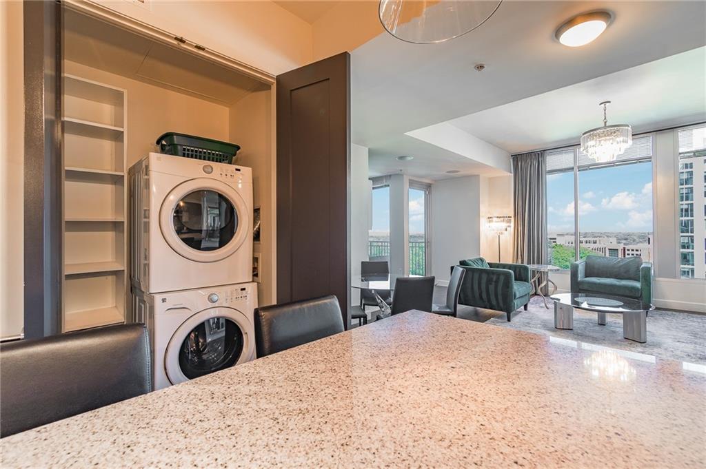 1820 Peachtree Road Northwest, Unit 1111 Atlanta, GA 30309 - Photo 29 of 41 a view of a bedroom with washer and dryer