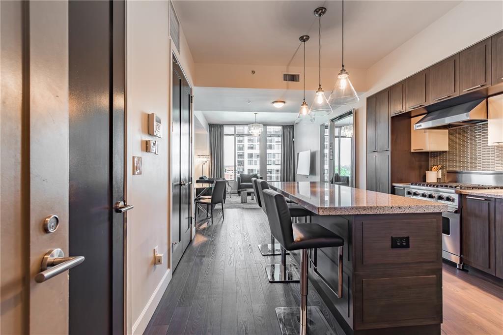 1820 Peachtree Road Northwest, Unit 1111 Atlanta, GA 30309 - Photo 3 of 41 a view of a kitchen and dining table
