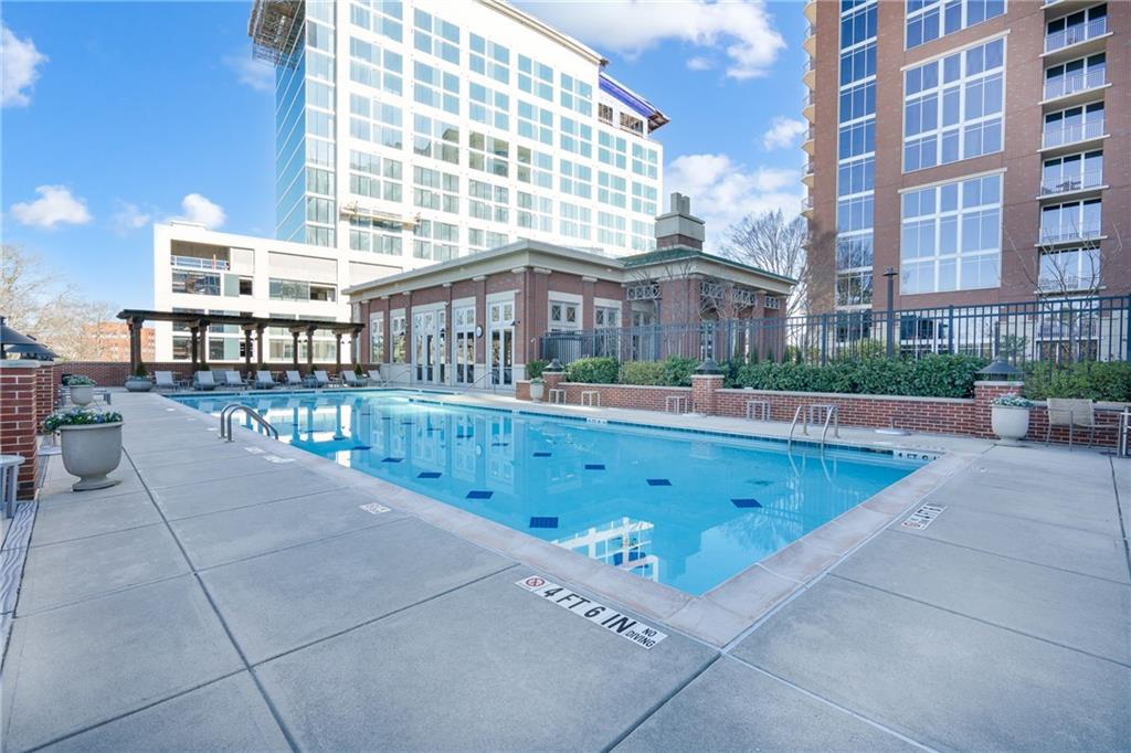 1820 Peachtree Road Northwest, Unit 1111 Atlanta, GA 30309 - Photo 37 of 41 a view of a swimming pool with a patio