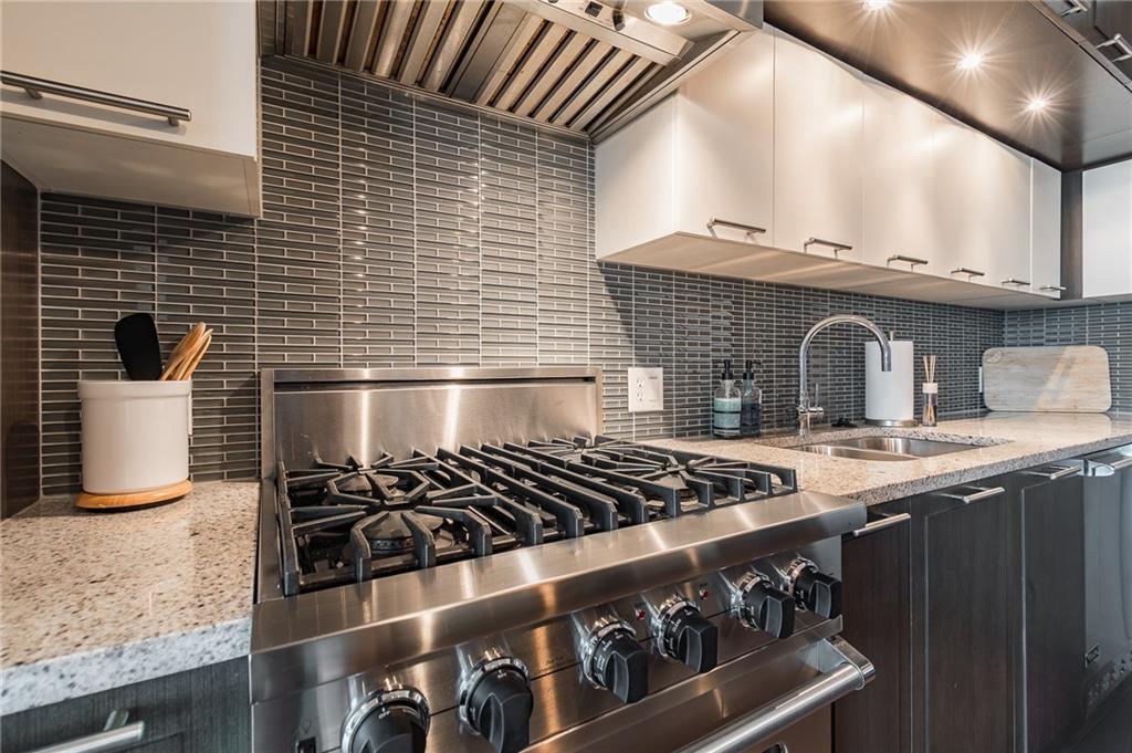 1820 Peachtree Road Northwest, Unit 1111 Atlanta, GA 30309 - Photo 4 of 41 a kitchen with a stove and a sink