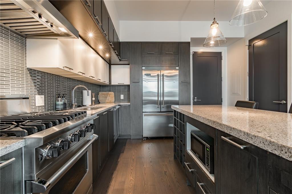 1820 Peachtree Road Northwest, Unit 1111 Atlanta, GA 30309 - Photo 5 of 41 a kitchen with stainless steel appliances granite countertop a sink a stove and a refrigerator