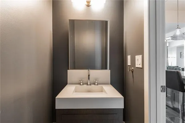 a bathroom with a sink a toilet and mirror