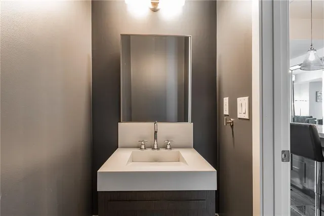 a bathroom with a sink a toilet and mirror