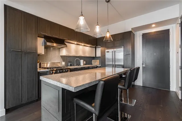 a large kitchen with a table and chairs