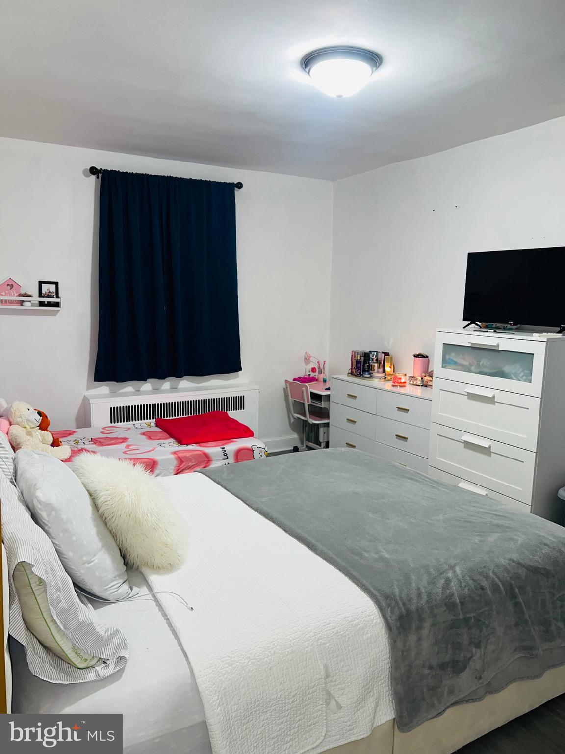 3019 St Vincent Street Philadelphia, PA 19149 - Photo 18 of 33 a room with a bed and flat screen tv