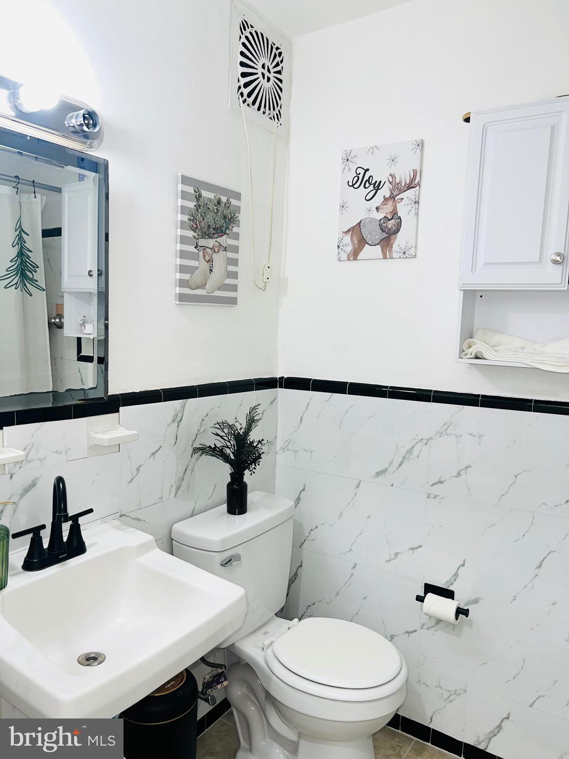 3019 St Vincent Street Philadelphia, PA 19149 - Photo 20 of 33 a bathroom with a sink mirror and toilet