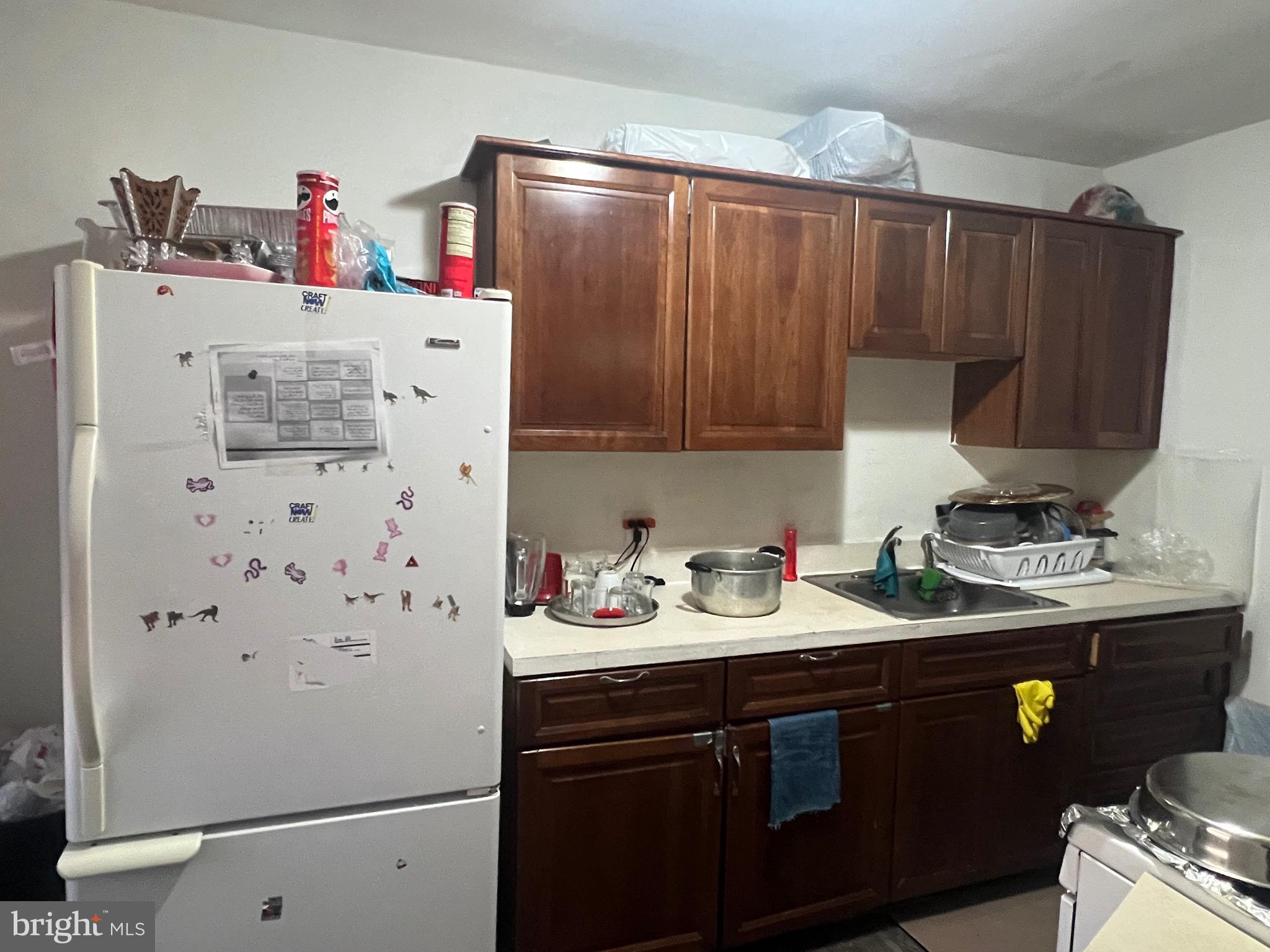 3019 St Vincent Street Philadelphia, PA 19149 - Photo 28 of 33 a kitchen with a sink a refrigerator and a stove top oven