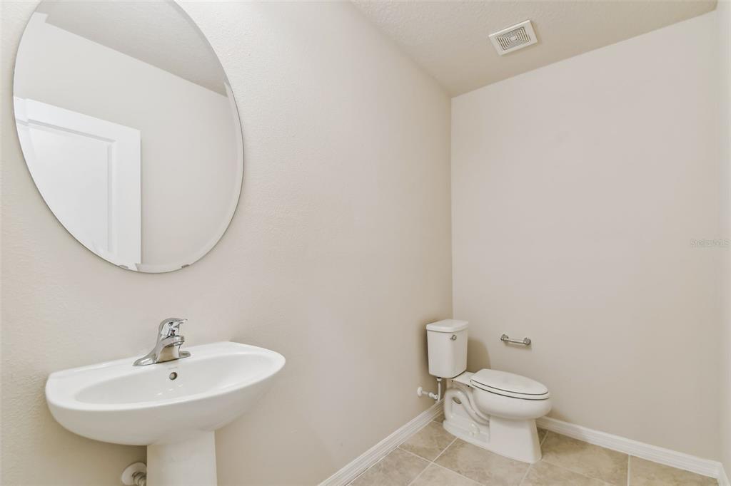 6885 Southwest 90th Place Ocala, FL 34476 - Photo 12 of 23 a bathroom with a sink a mirror and a toilet