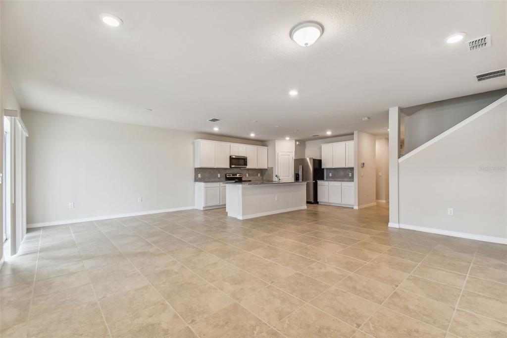 6885 Southwest 90th Place Ocala, FL 34476 - Photo 2 of 23 a view of kitchen with refrigerator and white cabinets