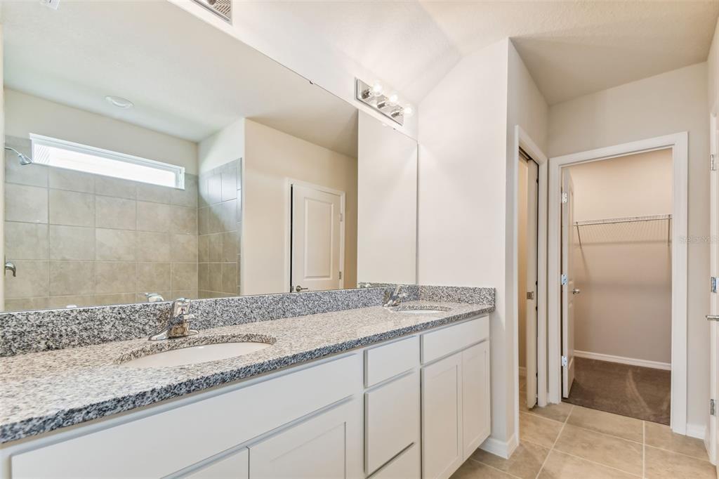 6885 Southwest 90th Place Ocala, FL 34476 - Photo 8 of 23 a bathroom with a granite countertop sink and a mirror