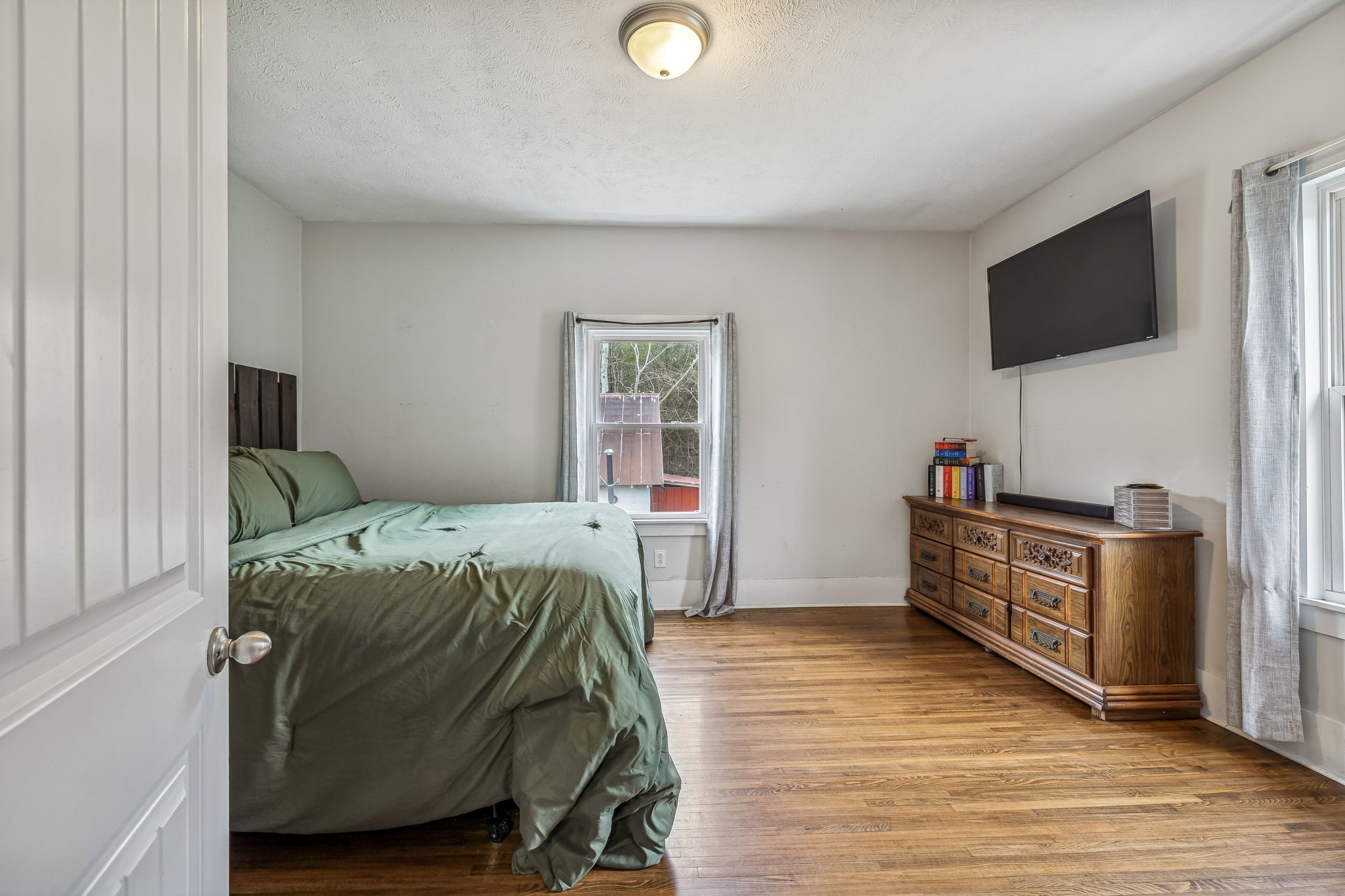 147 Sloan Branch Road Pleasant Shade, TN 37145 - Photo 29 of 53 a bedroom with furniture and a flat screen tv