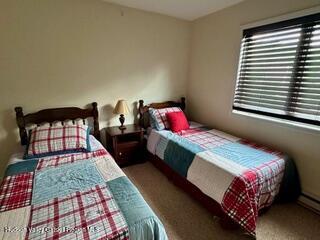 274 Brooksburgh Road, Unit 48 Hensonville, NY 12439 - Photo 22 of 30 a bedroom with a bed dresser and a window