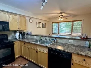 a kitchen with stainless steel appliances granite countertop a sink a stove and cabinets
