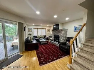 a living room with furniture fireplace and a table