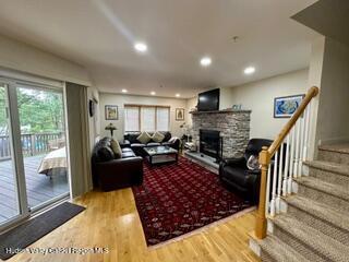 274 Brooksburgh Road, Unit 48 Hensonville, NY 12439 - Photo 10 of 30 a living room with furniture fireplace and a table
