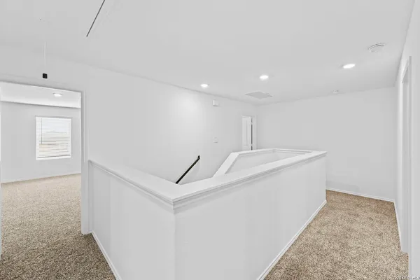 a view of a hallway with stairs