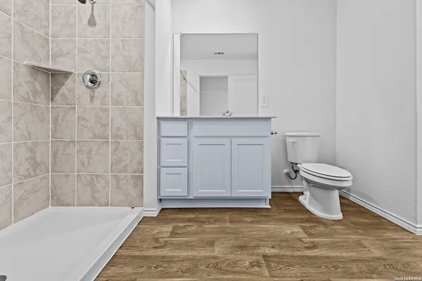 a bathroom with a toilet and a shower